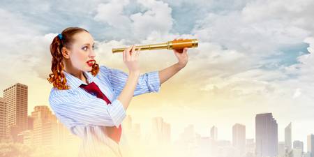 Image of young pretty woman looking in telescopeの写真素材