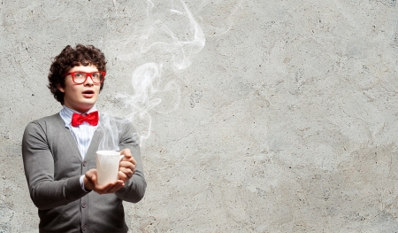 Young man with smoke coming out of a cup experimentingの写真素材
