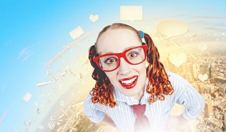 Funny looking red-hair woman with glasses staring at cameraの写真素材