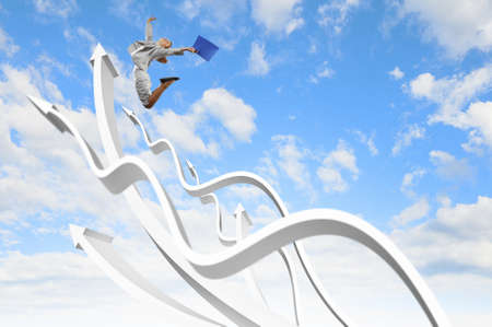 Young businesswoman jumping on white arrows  Growth conceptの写真素材