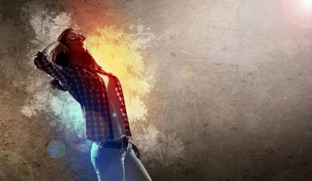 Image of young pretty woman with headphones dancingの写真素材