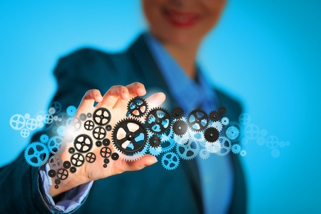 Image of businesswoman touching gear elements  Mechanism conceptの写真素材