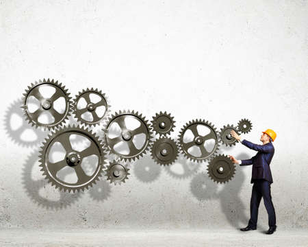 Businessman with cog wheel elements  Construction conceptの写真素材