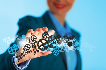 Image of businesswoman touching gear elements  Mechanism conceptの写真素材