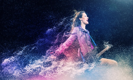 Young attractive rock girl playing the electric guitarの写真素材