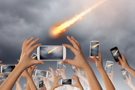 Close up of human hands taking photo of falling meteorite