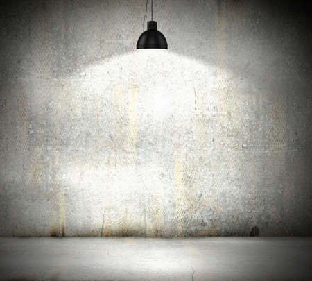 Stone blank wall illuminated with hanging above lamp  Place for textの写真素材