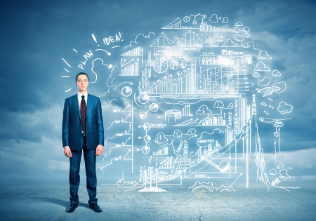 Image of young businessman standing against business sketchの写真素材