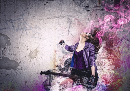 Young attractive rock girl playing the electric guitarの写真素材