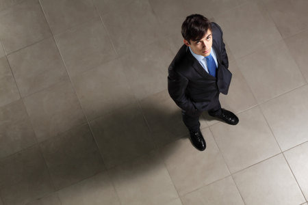 Image of young businessman looking above  Top viewの写真素材
