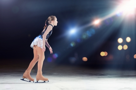 Little girl figure skating at sports arena Little girl figure skating at sports arena