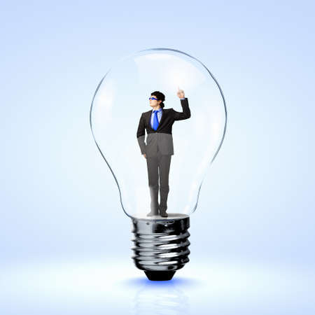 Image of young businessman in light bulb  New idea and inspirationの写真素材
