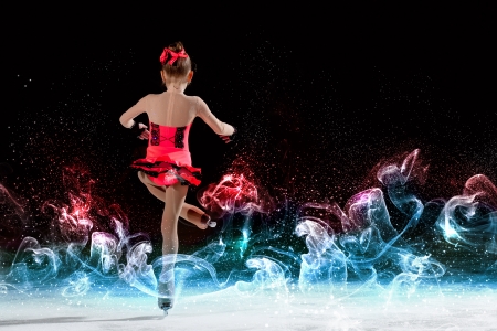 Little girl figure skating at sports arenaの写真素材