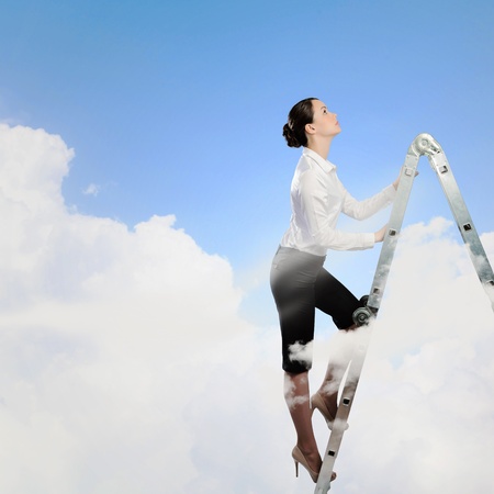 Image of young ambitious businesswoman climbing ladder  Promotion conceptの写真素材