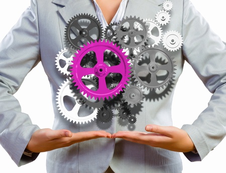 Close up image of businesswoman holding gears in handsの写真素材