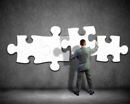 Image of businessman compiling macro white puzzle  Building businessの写真素材