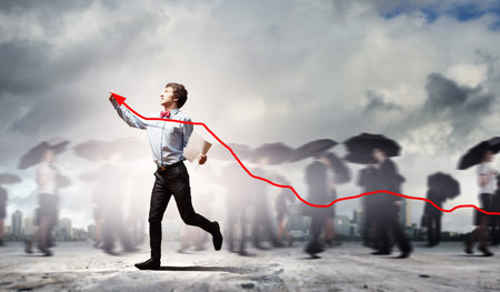 Image of young businessman drawing red graph