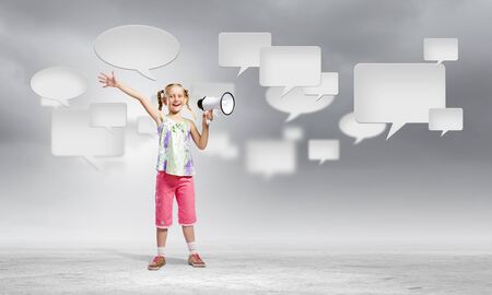 Image of little girl shouting into megaphoneの写真素材