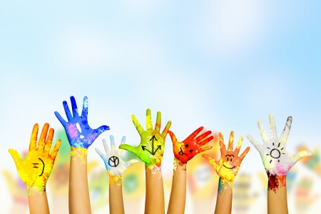 Image of human hands in colorful paint with smilesの写真素材