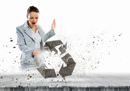 Image of businesswoman crashing recycle stone symbolの写真素材