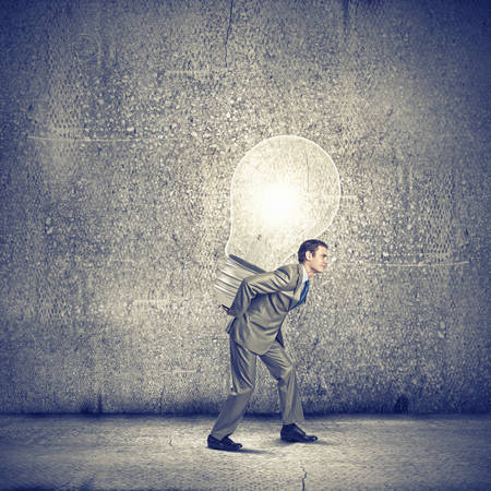 Image of businessman carrying bulb on back  New ideaの写真素材