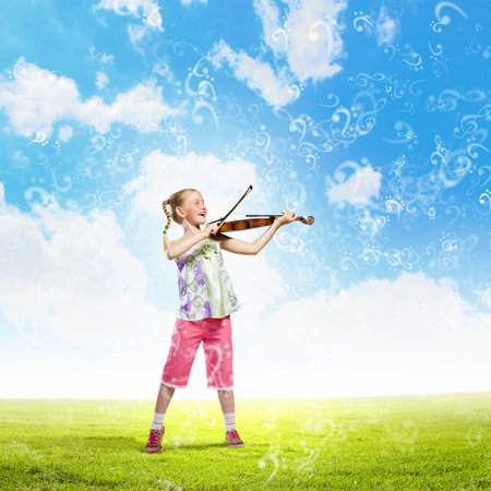 Image of cute girl playing violin outdoorsの写真素材