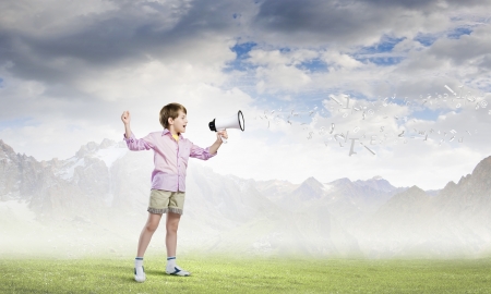 Image of little cute boy shouting in megaphoneの写真素材