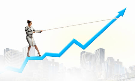 Image of businesswoman standing on graph  Income and profitの写真素材