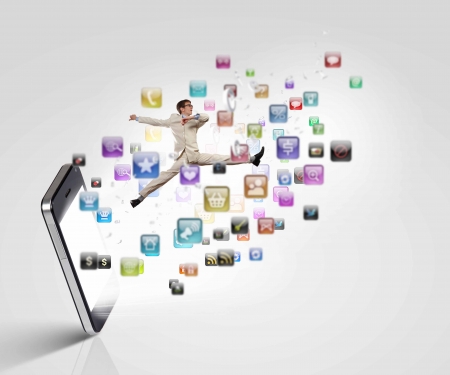Image of businessman jumping out of mobile phoneの写真素材