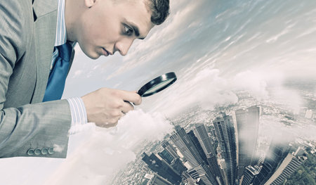 Image of businessman examining objects with magnifierの写真素材