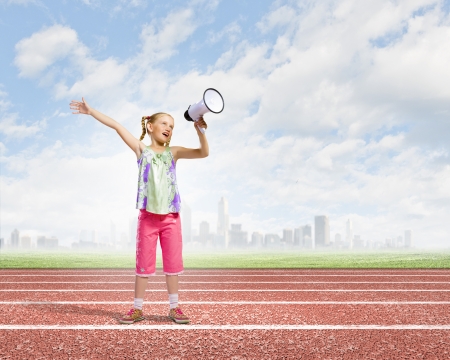 Image of little girl shouting into megaphoneの写真素材