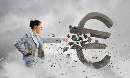 Image of businesswoman crashing stone euro symbolの写真素材