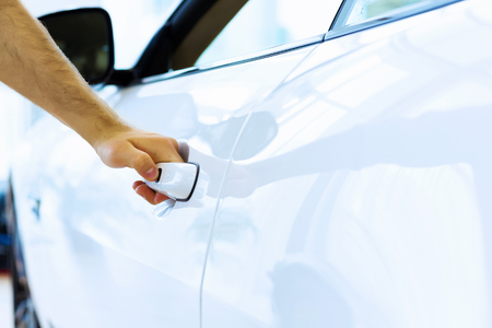Close up human hand opening car doorの写真素材