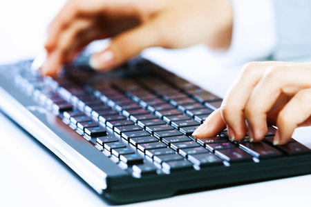 Close up image of businesswoman hands typing on keyboard
