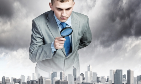 Image of businessman examining objects with magnifierの写真素材