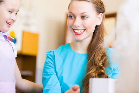 Little children painting and playing at kindergartenの写真素材