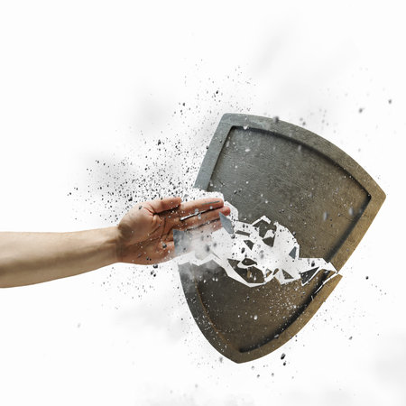 Close up of human hand breaking stone shield