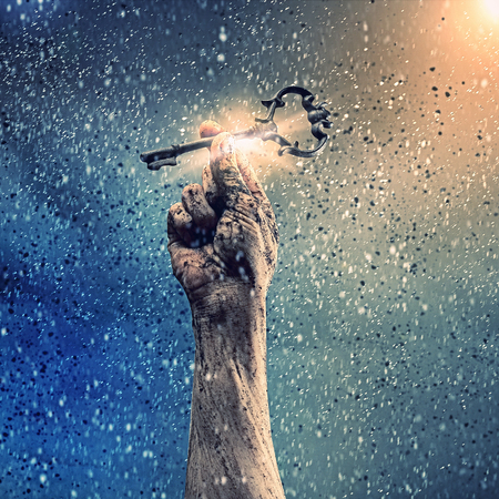 Key in human hand  Struggle and successの写真素材