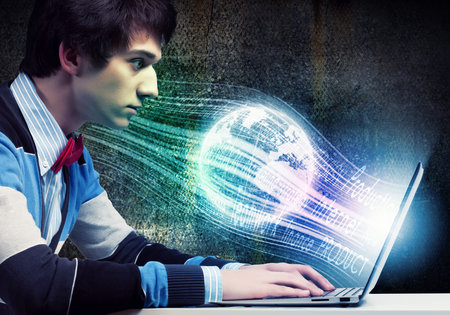 Image of young businessman at work using laptop