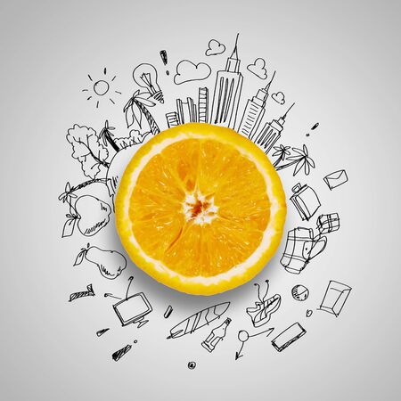 Orange half against background with business sketchesの写真素材