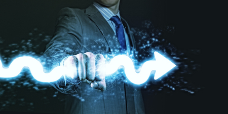 Businessman holding lightning in fist  Power and controlの写真素材