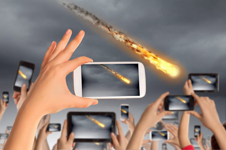 People taking photos of falling meteorite on mobile phone camera