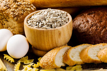 Fresh bread, eggs and macaroni on tableの写真素材