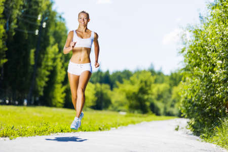 Image of young attractive woman running outdoorの写真素材