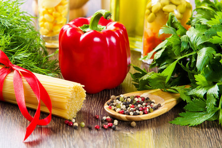 Close up of pepper and other ingredients on kitchen tableの写真素材