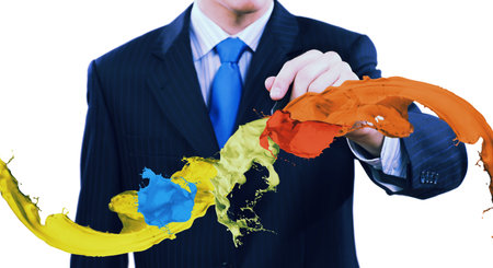 Businessman against white background drawing colorful splashes with markerの写真素材