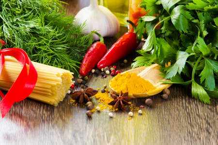 Chilli pepper macaroni herbs and splices on kitchen tableの写真素材