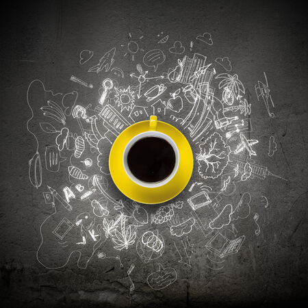 Cup of coffee with sketches at backgroundの写真素材