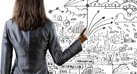 Back view of businesswoman drawing plan or strategyの写真素材