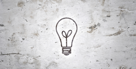 Electrical bulb against grey wall  Strategy and thinkingの写真素材